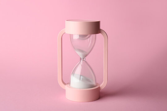 Crystal hourglass on pink background