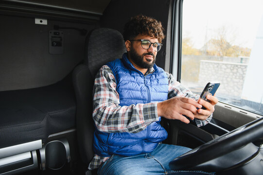 Truck driver using phone during break in cabin