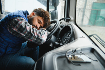 Truck driver sleeping at steering wheel during break