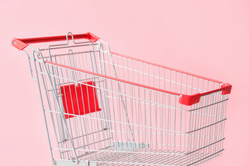 Shopping cart on pink background