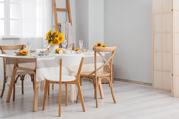 Elegant table serving with plates, glasses and beautiful sunflowers