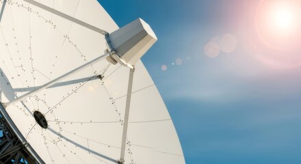 Satellite dish antenna capturing signals under sunny blue sky. Wireless communication technology for 5G networks and data transmission. Modern telecommunications infrastructure for global