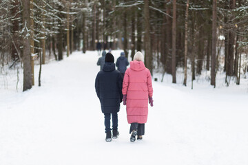 Nordic walking. People are practicing Nordic walking in the park.