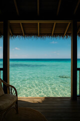 Obraz premium Tropical deck with wicker chair and turquoise ocean view from shaded beach hut