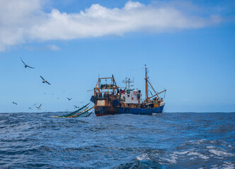 Oceanic trawler lifts trawl in the waters of the Southern Ocean.