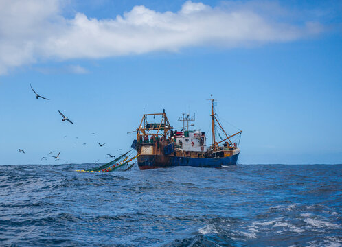 Oceanic trawler lifts trawl in the waters of the Southern Ocean.