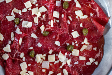 Beef Carpaccio cold appetizer with parmesan