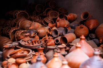 Handmade clay pottery assortment in a traditional workshop.