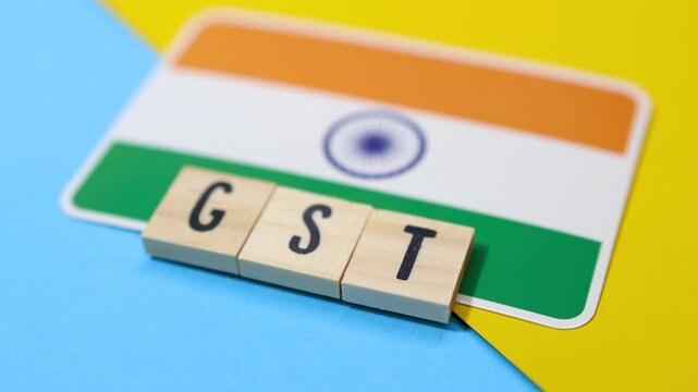 Concept of Goods and services Taxes (GST) in India created with text and Indian flag.
