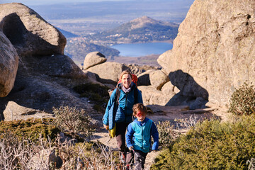 Woman walking in the mountains with her child