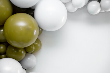 Minimalist balloon garland in white and olive tones forming a corner frame on a clean light background, perfect for celebrations, party decor, event branding and modern design layouts.