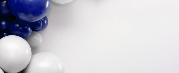 Blue and white balloon garland on a clean white background, festive decorative backdrop ideal for celebrations, parties, and event design.