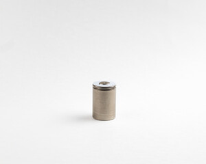 Cylindrical silver rechargeable battery with a decorative top on a white background