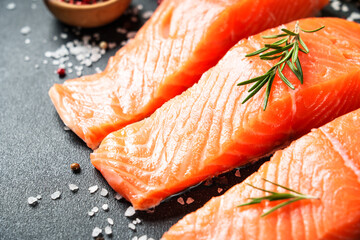 Salmon fillet, raw fresh fish with rosemary and spices.