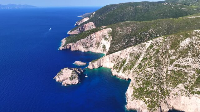 Aerial drone video of not so famous paradise bay and caves of Saint Andrews islet creating a blue lagoon visited by yachts and small boats in the Northern part of Zakinthos island, Ionian Sea, Greece