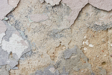Abstract background of peeling, old paint on the wall.