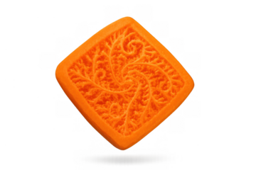 Orange square cookie with embossed textured swirl pattern and intricate details, isolated on transparent background
