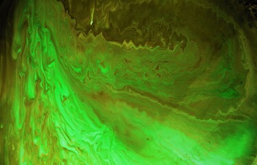 Green abstract background. The acrylic paint flows and creates a unique pattern. The texture of natural stone. The amethyst.
