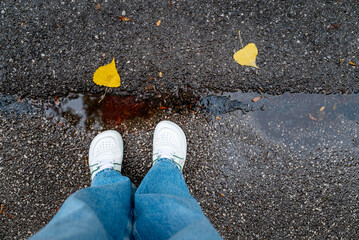 White barefoot shoes on wet asphalt background 