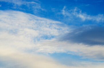 The sky is a brilliant blue with soft white clouds, creating a stunning natural backdrop