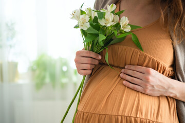 Delicate white blossoms complement expecting mother's gentle belly caress. Intimate moment of...