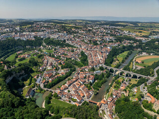 Panoramic aerial view of old medieval town of Fribourg, Switzerland in Europe. Bridges crossing the river, Swiss city on a summer day.