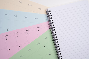 Open notebook for task list on pastel calendar background. Multi-Project Planning. 