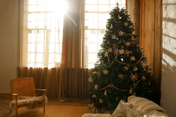 Elegant Christmas tree in cozy living room with warm sunlight streaming in