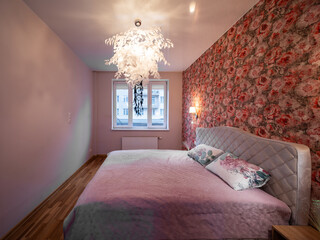 The bedroom in the apartment is in colorful bright red tones.