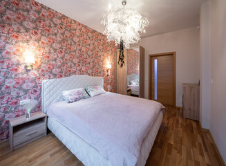 The bedroom in the apartment is in colorful bright red tones.