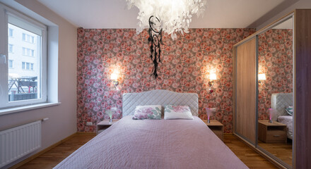 The bedroom in the apartment is in colorful bright red tones.