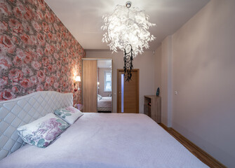 The bedroom in the apartment is in colorful bright red tones.