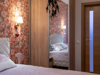 The bedroom in the apartment is in colorful bright red tones.
