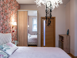 The bedroom in the apartment is in colorful bright red tones.