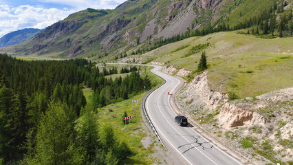 A cyclist rides along the Chuy Highway in the Altai Mountains, as seen from a drone