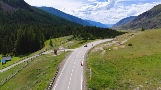 A cyclist rides along the Chuy Highway in the Altai Mountains, as seen from a drone