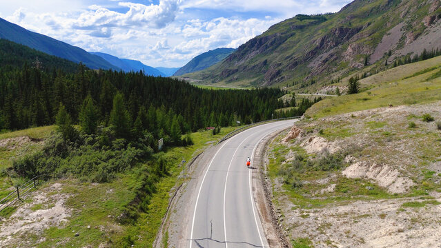 A cyclist rides along the Chuy Highway in the Altai Mountains, as seen from a drone