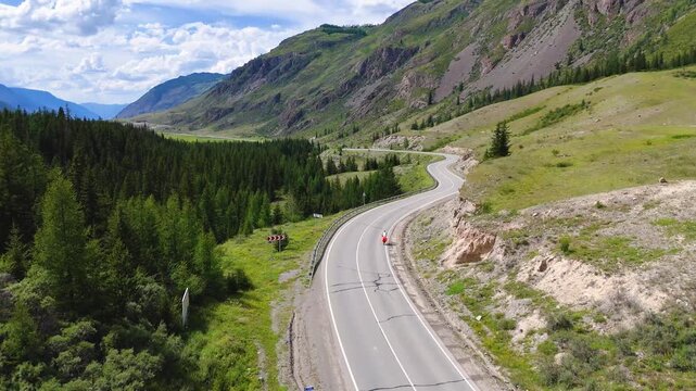 A cyclist rides along the Chuy Highway in the Altai Mountains, as seen from a drone