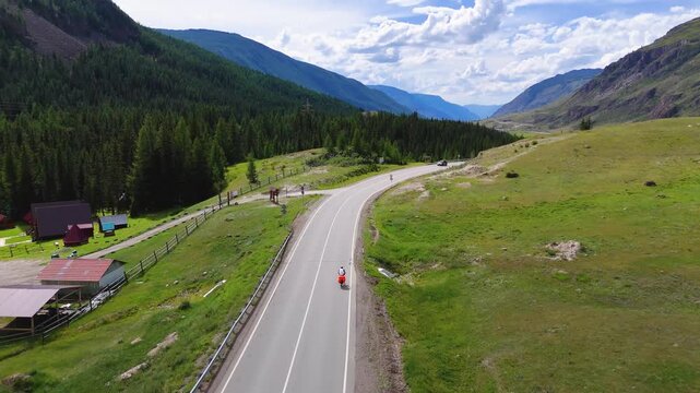A cyclist rides along the Chuy Highway in the Altai Mountains, as seen from a drone
