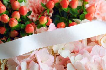 Elegant floral arrangement with pink hydrangeas, red hypericum berries, and white ribbon, perfect for wedding or romantic decor
