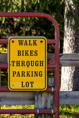 Walk bikes through parking lot sign