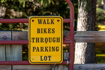 Walk bikes through parking lot sign