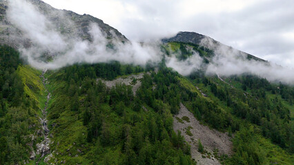 fog over the rocky mountains in Altai, view from a drone
