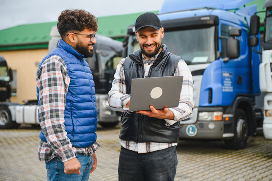 Truck driver checking logistics data with manager