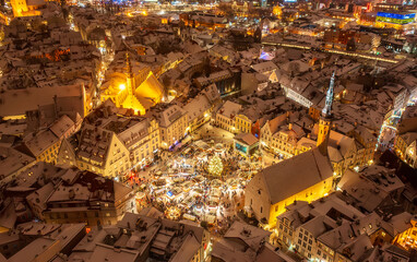 Aerial night View of Tallinn with the Town Hall Square in winter, roofs with snow, Christmas mood