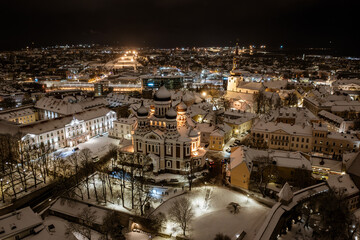 Aerial night View of Tallinn in winter with Alexander Nevsky Cathedral, roofs with snow, Christmas mood