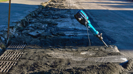 Repair road.Jackhammer for breaks up old asphalt