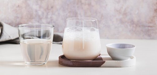 Cloudy pink matcha with coconut water in a glass on the table web banner