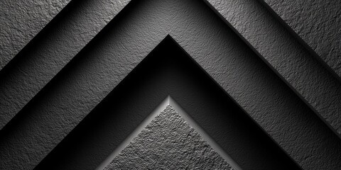 Abstract black geometric chevron pattern with rough granular texture and shadows.

