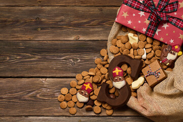 Obraz premium Festive Sinterklaas Treats. A festive display of Sinterklaas treats, chocolate letters, and gifts